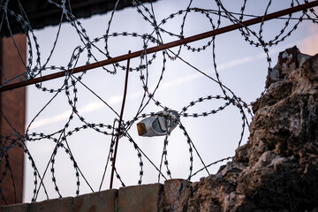 barbed wire fence with white shoe