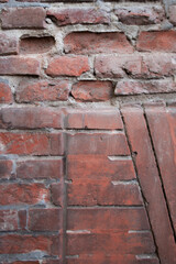 A close detail of a brick wall. Red brick cladding in different directions.