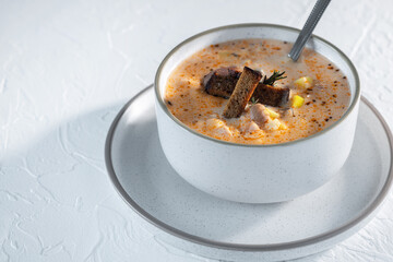 Cheese cream soup with mushrooms, potatoes and croutons, tasty first course
