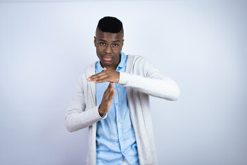 Young handsome african american man wearing casual clothes Doing time out gesture with hands,...