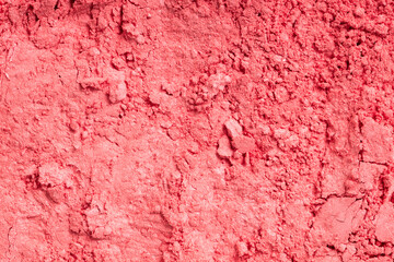 Smashed coral eyeshadow. Close-up of a makeup product.