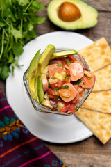 Wieners cocktail with avocado and ketchup on wooden background. Mexican food