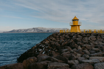 Fototapeta na wymiar Yellow lighthouse in Reykjavík, Iceland