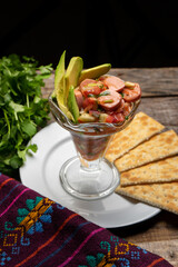 Wieners cocktail with avocado and ketchup on wooden background. Mexican food