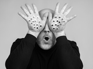 The man controls everything around. There are many eyes on the palm of the hand. Metaphor of...