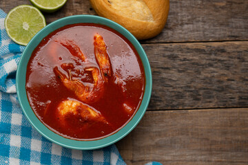 Shrimp soup on wooden background. Mexican food