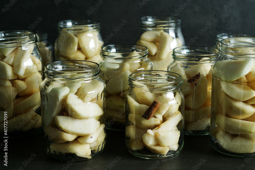 Wall mural closeup shot of glass transparent bottle jars filled with ripe peeled pear slices