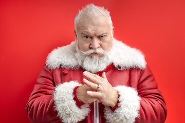 angry senior man expressing rigor,prepared fist isolated on red background, confidently looking at...