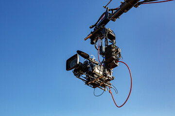 TV camera on a crane on a football match or concert.