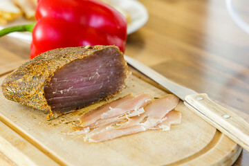Piece of homemade parma cold cut on wooden board