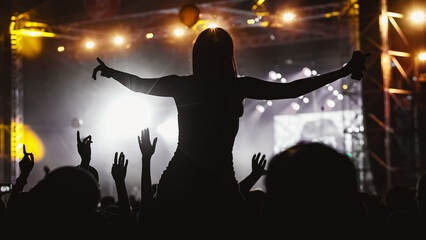 Girl silhouette on a big concert show.