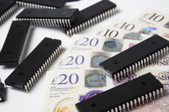 Semiconductor Chips Shortage And High Price. Pile Of Computer Chips And Spread Of  British Pound Banknotes. Concept For Crisis In The Industry.