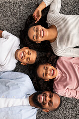 Portrait of african american family lying on floor together