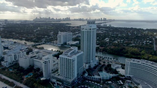 Aerial View Of Luxury Hotel Buildings Lining The Shore Of Mid-Beach Area In Miami Beach, Florida. drone orbit