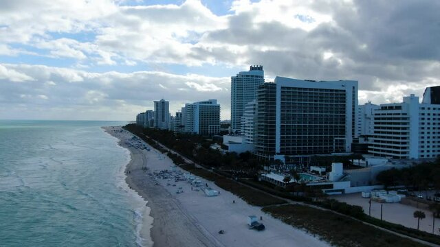 High-Rise Buildings Against Cloudscape At Dusk In Mid-Beach Area, Miami Beach, Florida USA. - Aerial Drone Shot