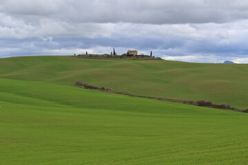 Tuscany, Italy. Isolated farm surrounded by green fields. 