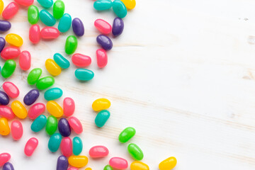 colorful jelly beans on white with copy space