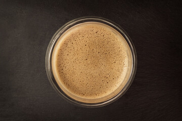 Coffee Foam on Black Slate. Copy space.  Minimal concept.
