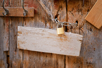 Padlocked on old wooden door.