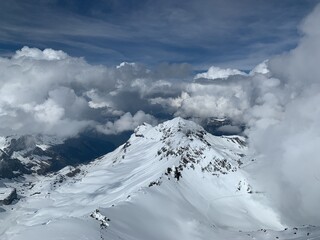 Fototapeta na wymiar A panoramic view of snow capped Alps and glaciers seen from Schilthorn, Switzerland