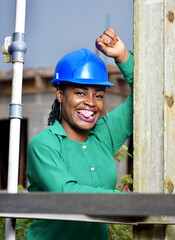 An attractive African Nigerian female construction and architectural engineer with blue safety helmet 