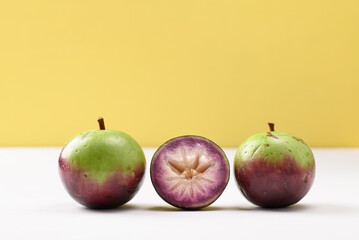 Ripe star apple fruit on white and yellow background, Tropical fruit