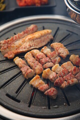 Grilled pork on an iron plate. 철판위에서 노릇노릇 익어가고 있는 돼지고기
