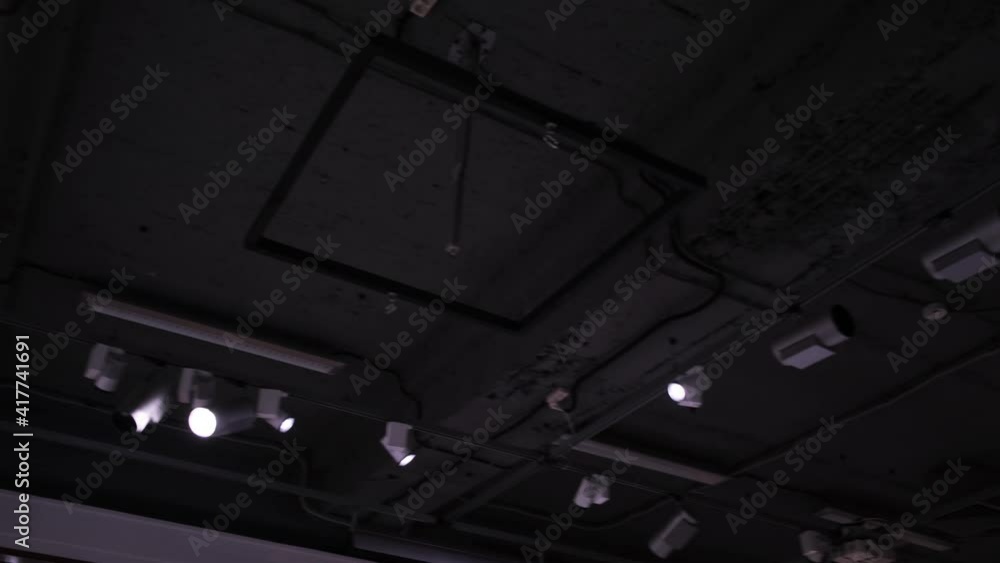 Poster bottom view of a ceiling with spotlights. concept. lighting of a dark room or stage with many soffit