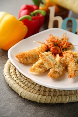 Baked dumplings on a white plate 흰색접시위에 노릇노릇하게 구워진 만두