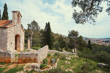 Ancient small catholic chapel made from stones with tiled roof.