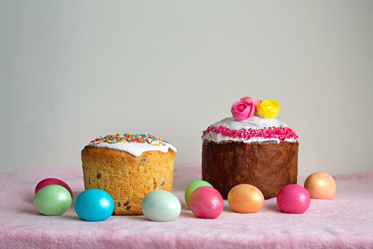 Traditional Slavic Easter cake decorated with sprinkles. Colored chicken eggs. Spring celebration event.