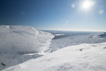 Winter landscape. Mountain snow-covered slope in cold polar winter on a sunny day
