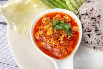 Nam phrik ong is a popular Thai food in Northern Thailand. Composition with rice, pork and fresh vegetables as cucumber, Chinese cabbage, cow pea, eggplant. 