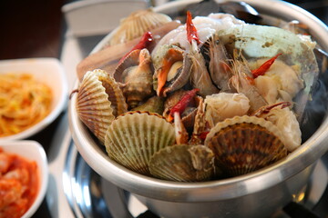 Steamed seafood dish with steaming and fresh seafood 김이 모락모락 나고신선한 해산물이 들어가 있는 해산물찜 요리