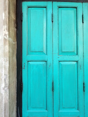 Old rustic wooden doors painted in blue.