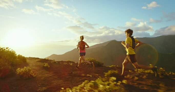 Running on mountain trail at sunset, epic adventure, healthy fitness lifestyle, training for marathon