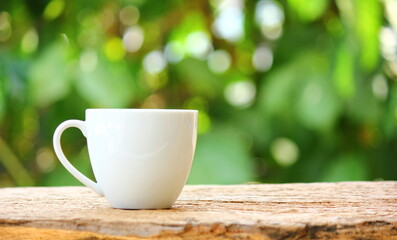 white ceramic coffee cup on retro floor with green background