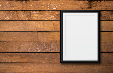 White poster or a white picture frame hanging on the wood wall background in the room.