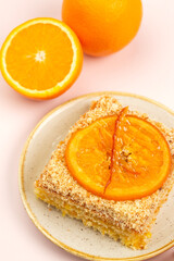 Naklejka na ściany i meble Piece go cake with orange cream and orange fruit