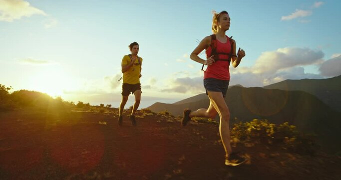 Athletic man and woman running on mountain trail, healthy fitness lifestyle. Jogging on trail, training for marathon
