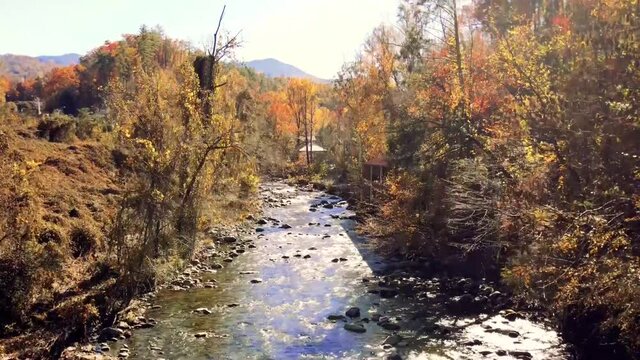 Drone flight autumn over river - Pigeon Forge Tennessee