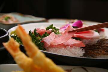 Chopsticks holding sashimi on a simple background  심플한 배경에 회를 집고있는 젓가락