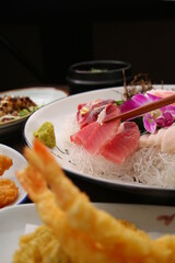 Chopsticks holding sashimi on a simple background  심플한 배경에 회를 집고있는 젓가락