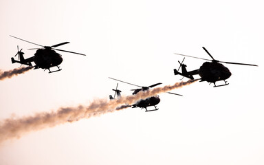 Indian Air Force Sarang helicopter air display team flying HAL Dhruv aircraft.