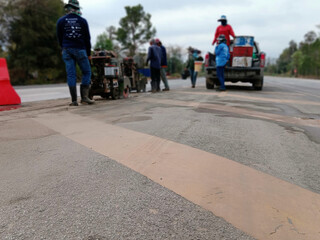 Blurred image of cutting-drilling of pavement to create an island in the middle of the road.