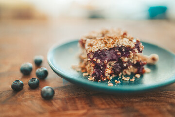 Blueberry crumble sweet fruits and oats crisp bar dessert plate at home.