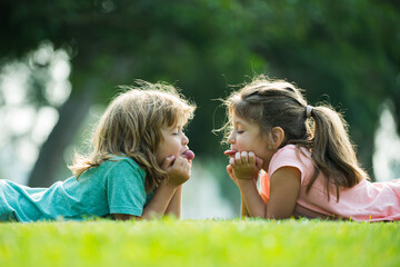 Child couple in love. Children or kids relationships. Little boy girl outdoors in park.