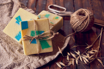 Fototapeta na wymiar A fragrant organic handmade soap with a geometric pattern and packaging items.