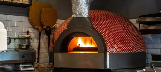 Wandaufkleber Typical Italian oven for bread and pizza. professional oven in interior of modern restaurant kitchen. Traditional baked wood fired oven © Надія Коваль
