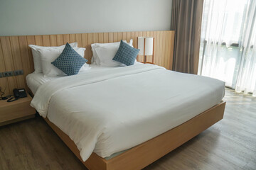 Fototapeta na wymiar minimal double bed with white mattress in luxury hotel bedroom